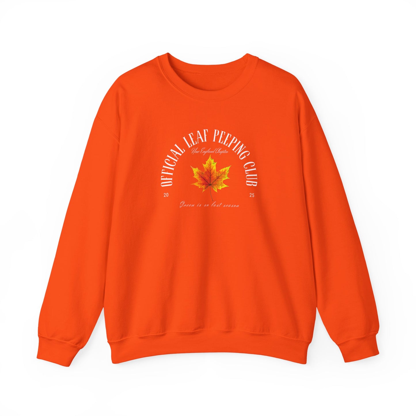A bright orange crewneck sweatshirt featuring a small cartoon illustration of a maple leaf and fall text the center chest, displayed against a clean white background.