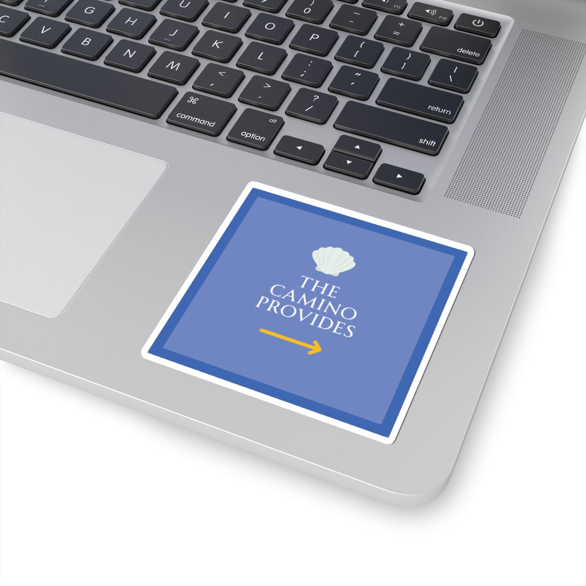 Laptop with a blue sticker reading 'The Camino Provides' on the palm rest area.