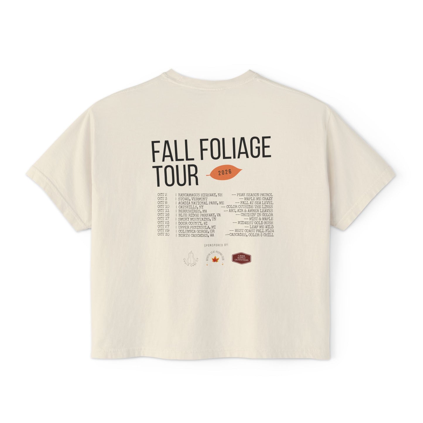 An off-white short-sleeve t-shirt showing the back side with a graphic print that reads 'FALL FOLIAGE TOUR 2026' above a tracklist and small illustrations, photographed on a solid white background.
