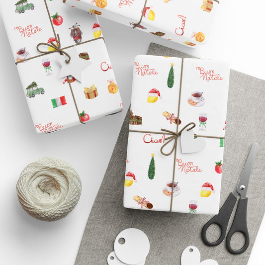 Gift wrap with Italian Christmas designs, scissors, and yarn on a gray surface