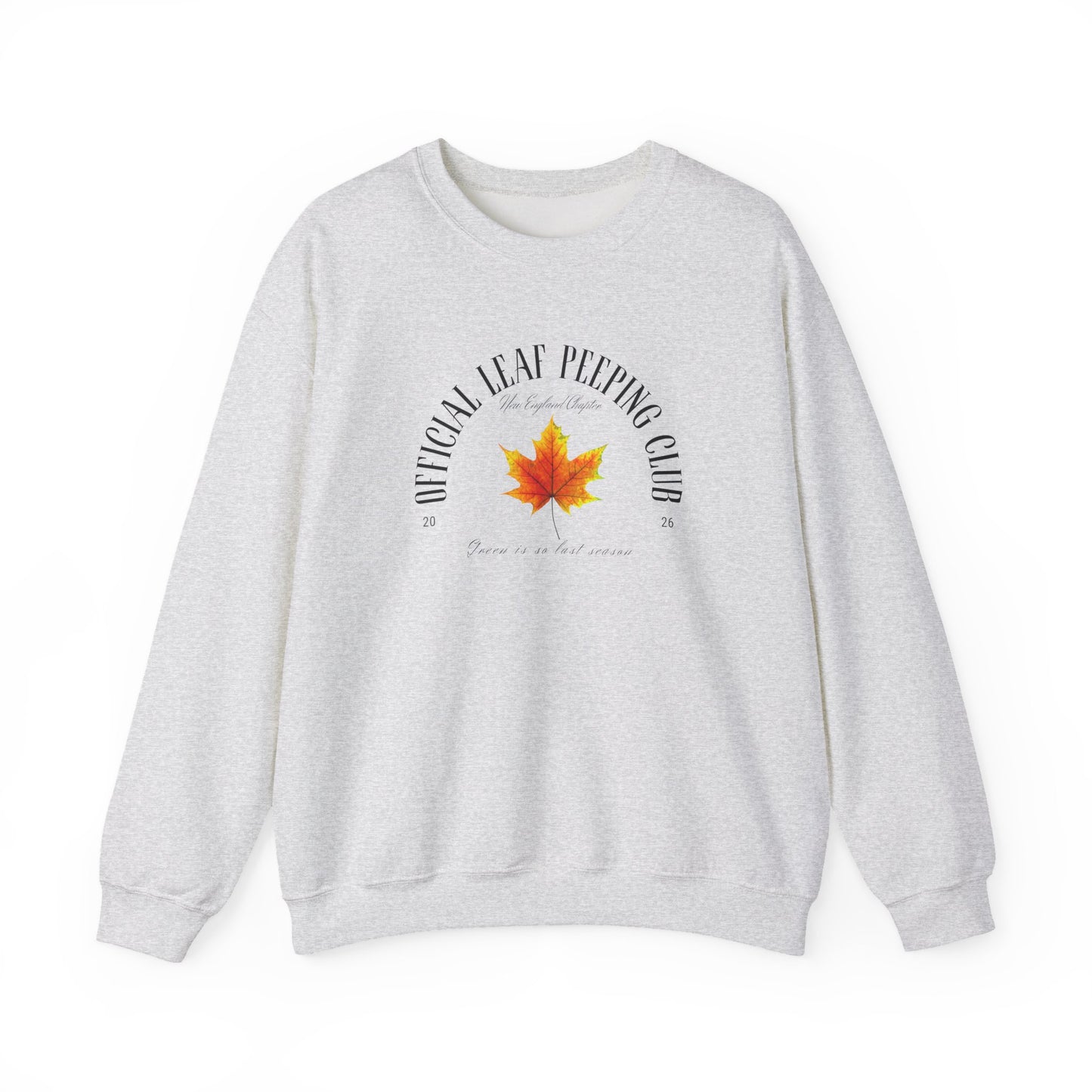A light heather gray crewneck sweatshirt featuring a graphic print on the front with a red and orange maple leaf in the center, surrounded by the text 'OFFICIAL LEAF PEPPING CLUB' and 'Born in a cold climate'.