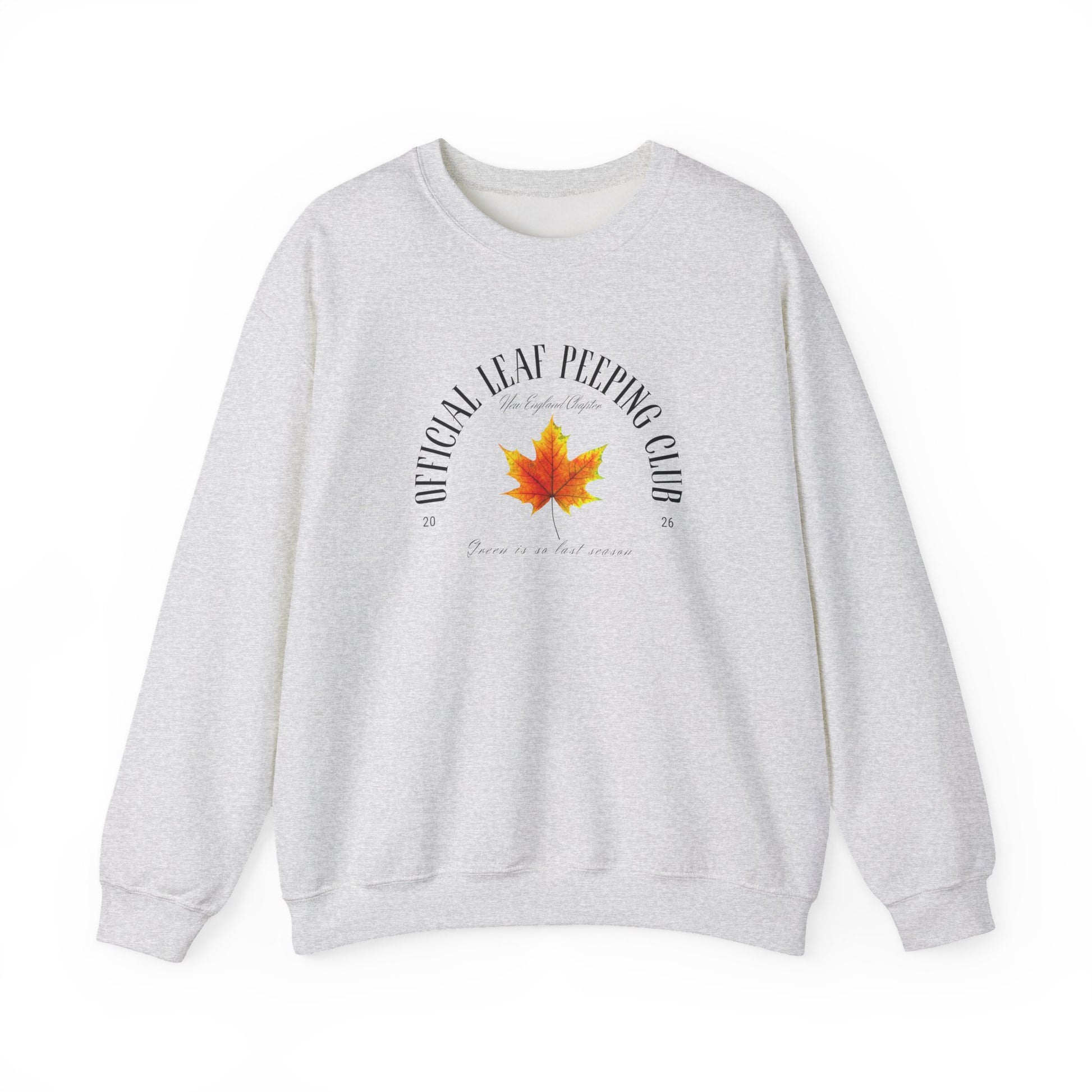 A light heather gray crewneck sweatshirt featuring a graphic print on the front with a red and orange maple leaf in the center, surrounded by the text 'OFFICIAL LEAF PEPPING CLUB' and 'Born in a cold climate'.