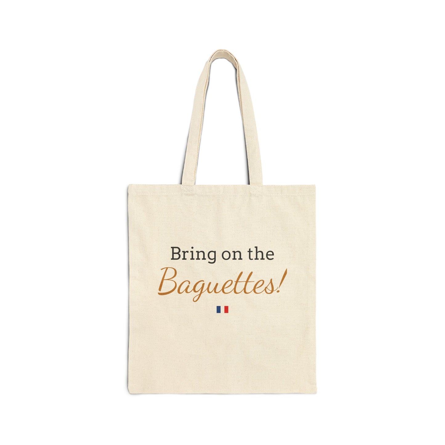 Beige tote bag with 'Bring on the Baguettes!' text and French flag on a white background