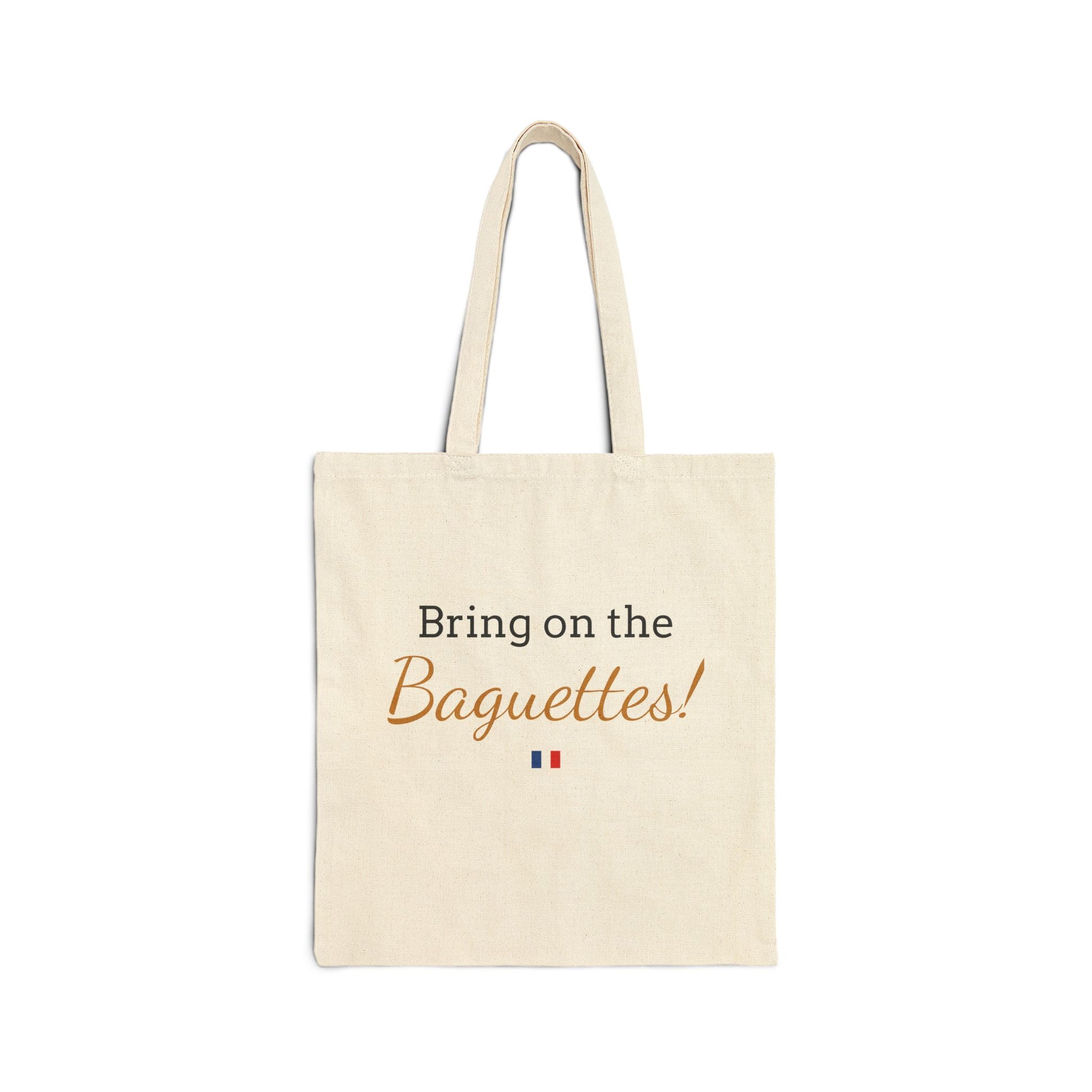 Beige tote bag with 'Bring on the Baguettes!' text and French flag on a white background