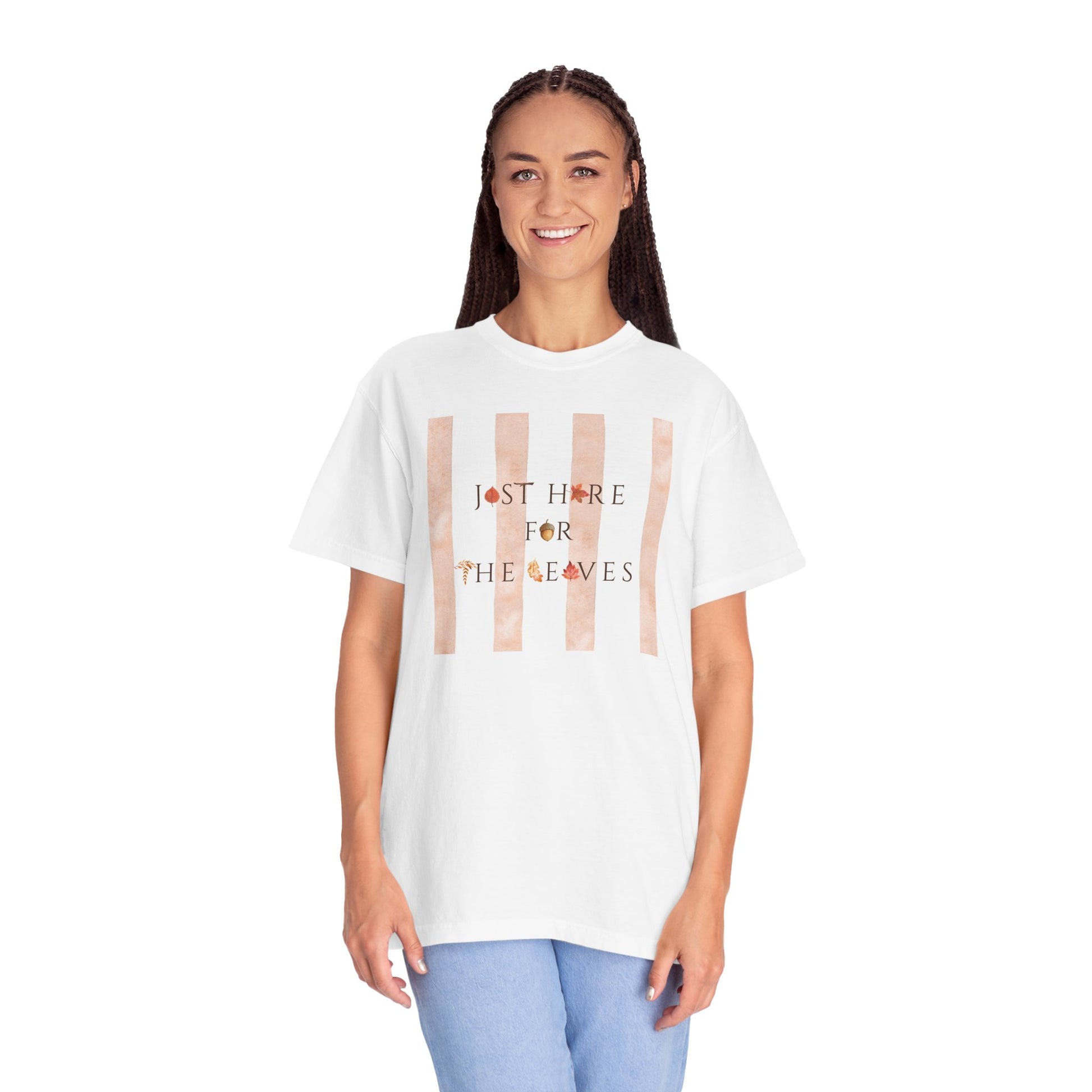 Person wearing a white t-shirt with fall leaves text and graphic on a white background
