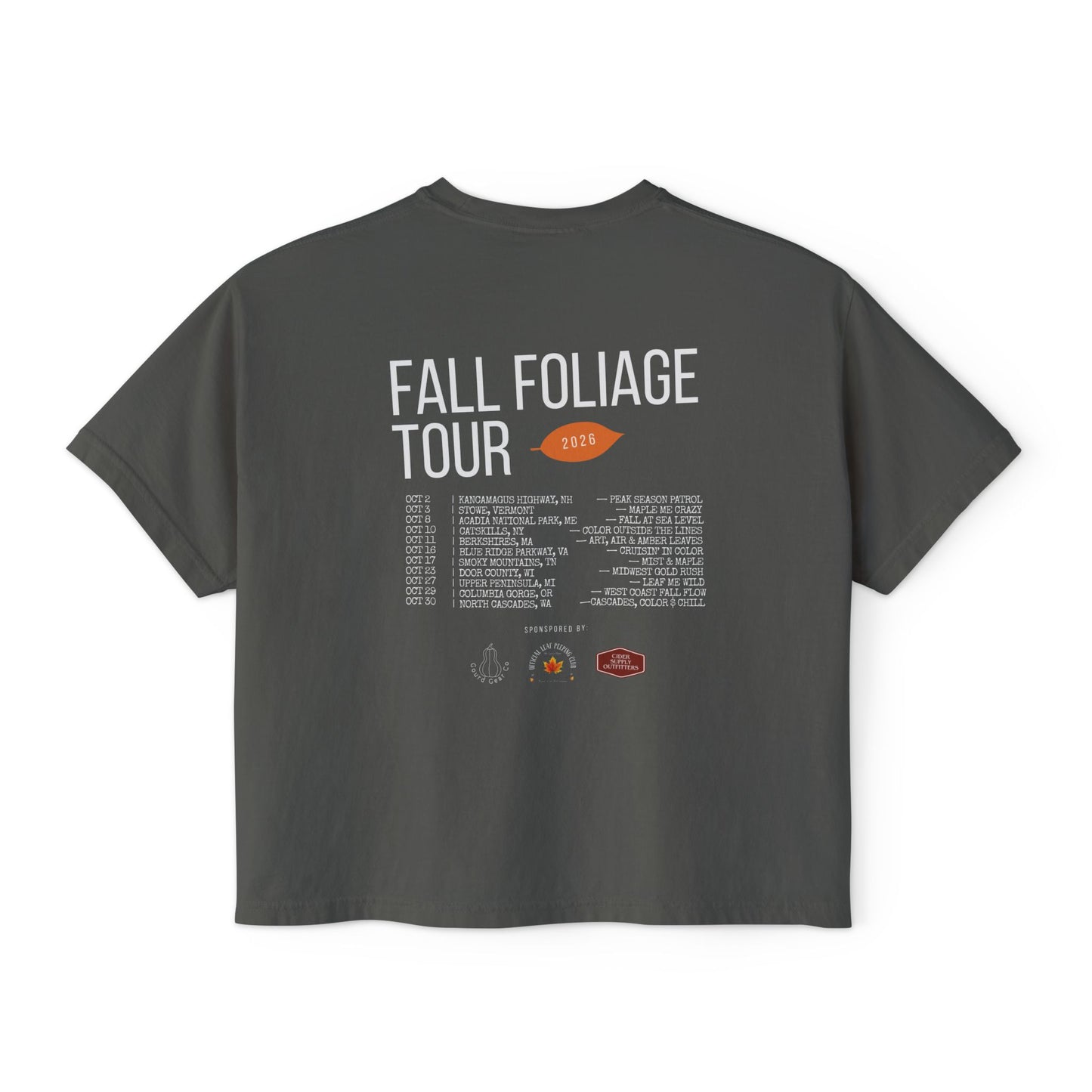A dark gray t-shirt shown from the back, featuring a white and orange graphic print that reads 'FALL FOLIAGE TOUR 2025' with a list of venues and logos at the bottom.