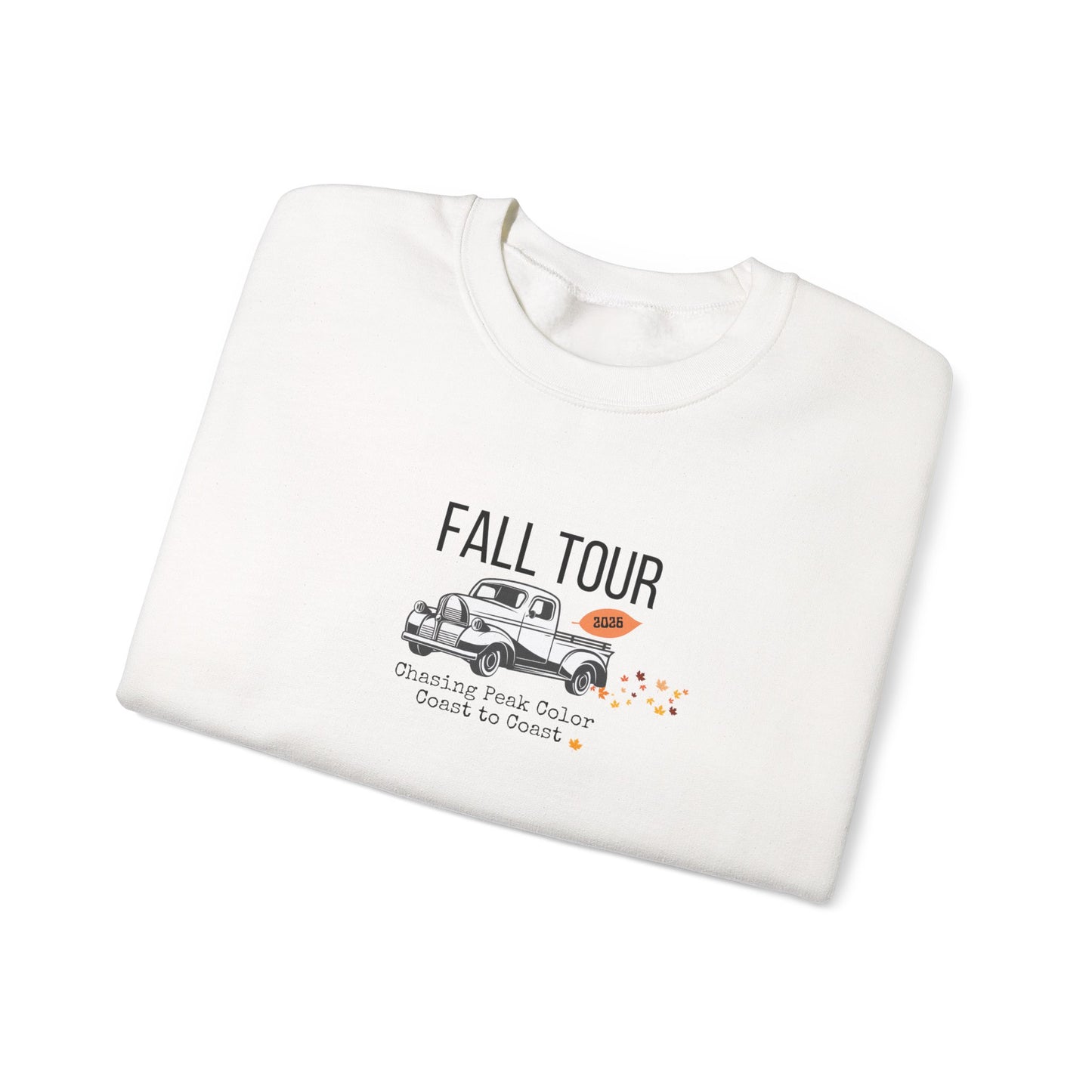 A folded off-white crewneck sweatshirt with a vintage truck graphic and the text 'FALL TOUR' and 'Guessing Pink Color Count to 10' on a clean white background.