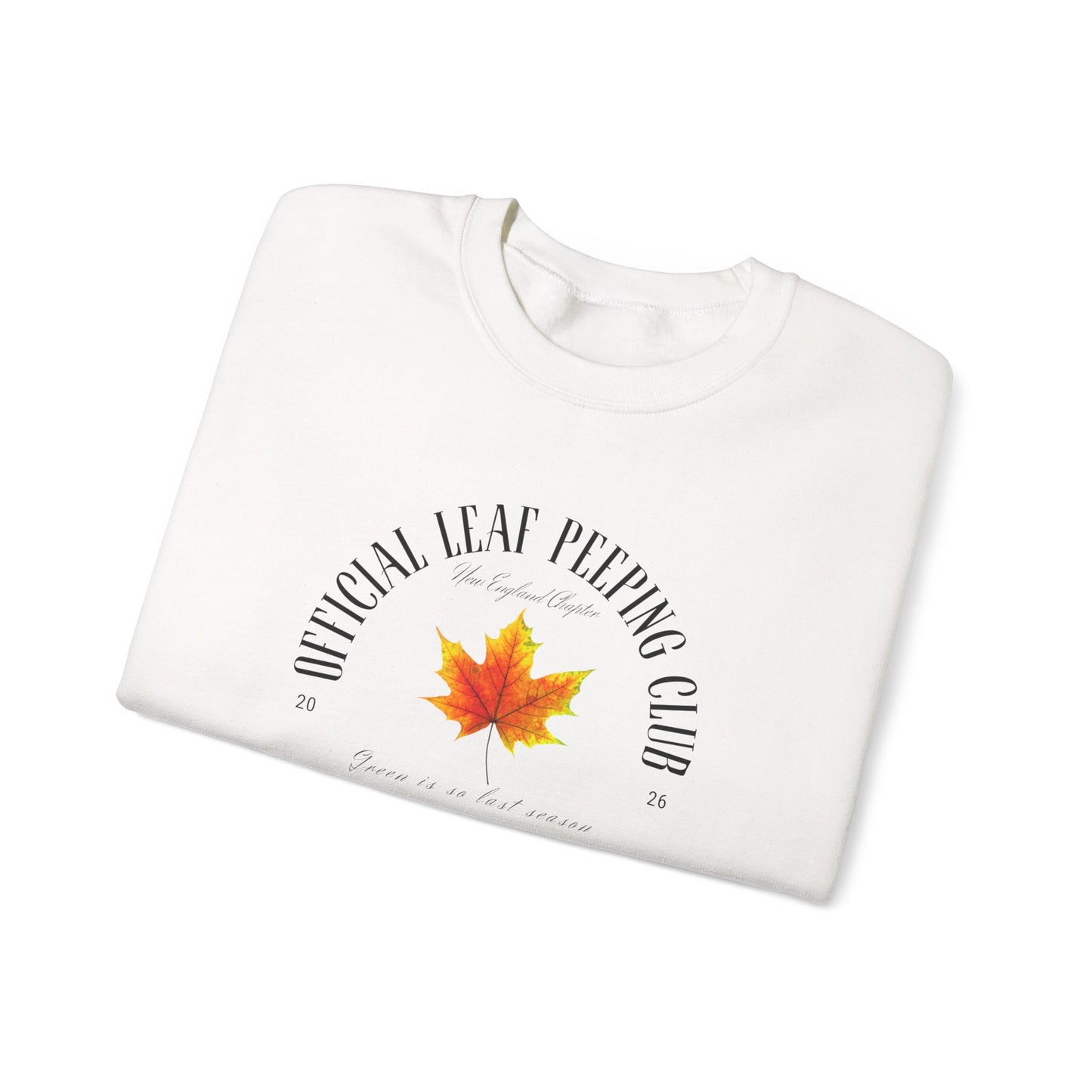 A folded white crewneck sweatshirt featuring a graphic print of a yellow and orange maple leaf with the text 'UNICLAL LEAF PEEPING CLUB' arched above it, displayed on a clean white background.